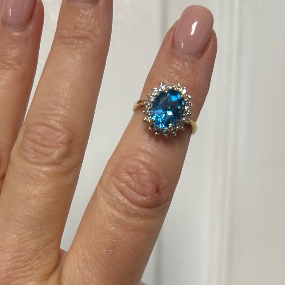 Elegant Blue Topaz with 1/5 Diamond halo set in Gold